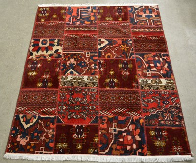 Lot 872 - A Persian patchwork carpet formed from four...