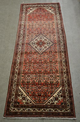 Lot 876 - A Persian Hamadan runner, the abrashed madder...