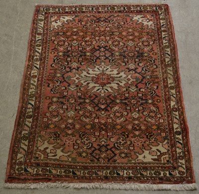 Lot 881 - A Persian rug, 20th century, the madder ground...