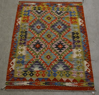 Lot 882 - A Chobi Kilim rug, the orange coloured ground...