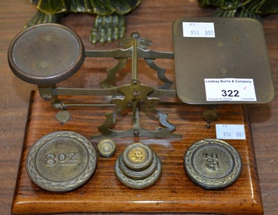 Lot 322 - A 20th century brass and oak desk top postal...