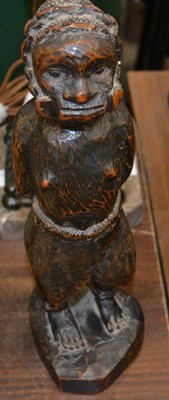 Lot 333 - A carved wooden primitive African figure of a...