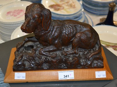 Lot 341 - A carved oak sculpture of a sitting hound...