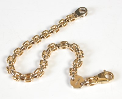 Lot 35 - An 18ct gold bracelet, inscribed on circular...