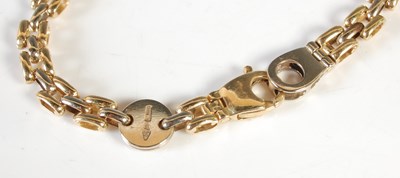 Lot 35 - An 18ct gold bracelet, inscribed on circular...