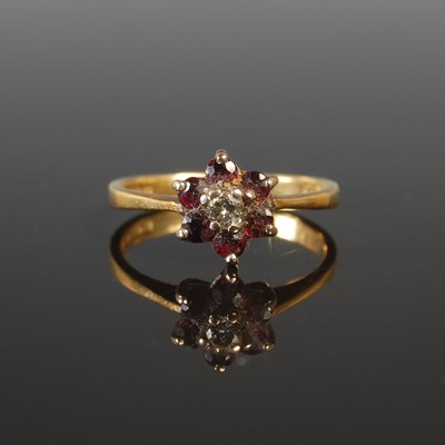 Lot 38 - An 18ct gold diamond and garnet cluster ring,...