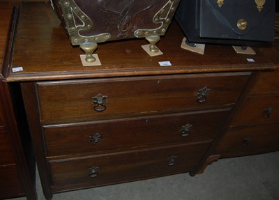Lot 778 - An oak chest of three long graduated drawers...