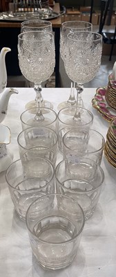 Lot 377 - A set of four cut crystal wine glasses raised...