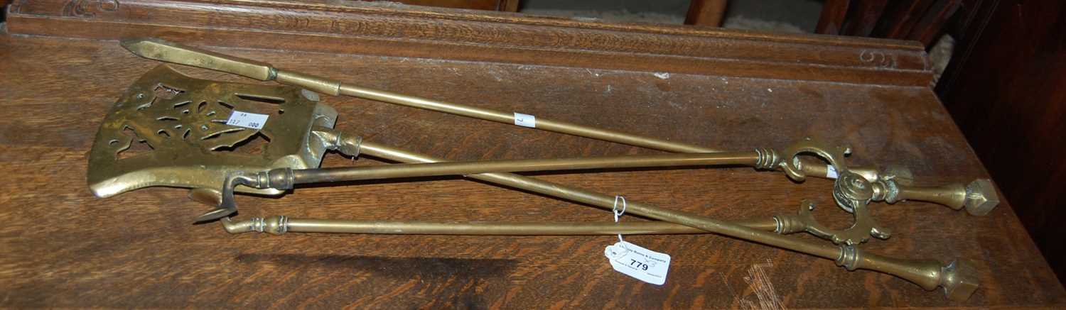 Lot 779 - A brass three piece fire tool set, comprising...