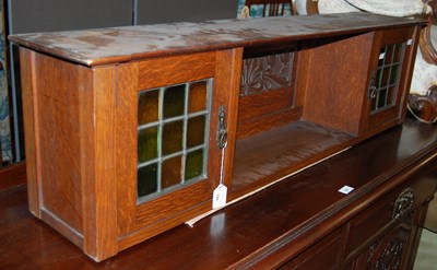 Lot 780 - An Art Nouveau oak hanging shelf, the open...