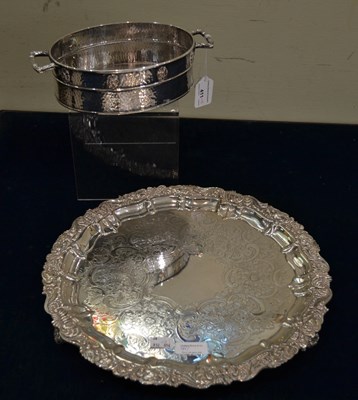 Lot 411 - A silver plated circular tea tray with floral...