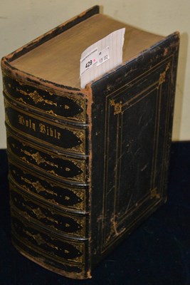 Lot 429 - A large Holy Bible bound in black leather,...