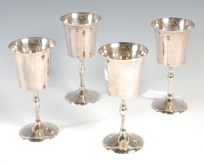 Lot 124 - A set of four silver plated goblets, 15cm high.