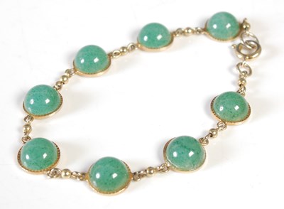 Lot 167 - A gold plated and green stone set bracelet,...