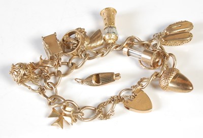Lot 174 - A 9ct gold charm bracelet suspending 11...