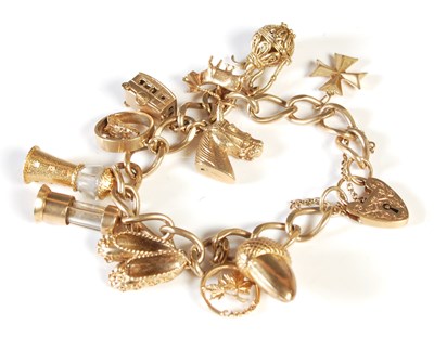 Lot 174 - A 9ct gold charm bracelet suspending 11...