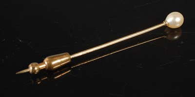 Lot 175 - A yellow metal and pearl topped stick pin,...