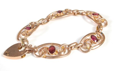 Lot 177 - A yellow metal and garnet set bracelet, formed...