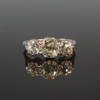 Lot 189 - A white metal three stone diamond ring,...