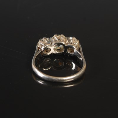 Lot 189 - A white metal three stone diamond ring,...