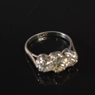 Lot 189 - A white metal three stone diamond ring,...