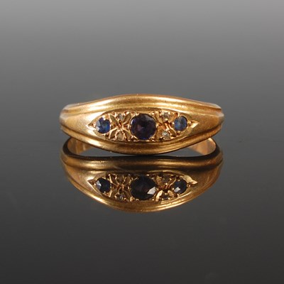 Lot 198 - An 18ct gold sapphire and diamond chip dress...