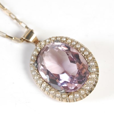 Lot 203 - A 9ct gold necklace suspending a yellow metal...