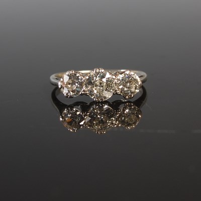 Lot 193 - A white metal three stone diamond ring centred...
