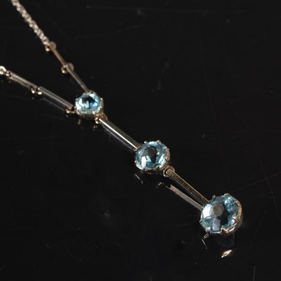 Lot 242 - A white metal and three stone aquamarine...