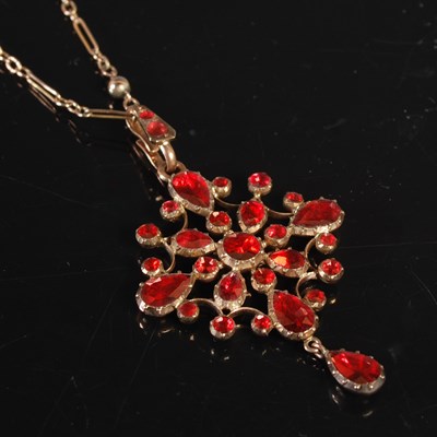 Lot 244 - A yellow metal garnet set pendant necklace,...