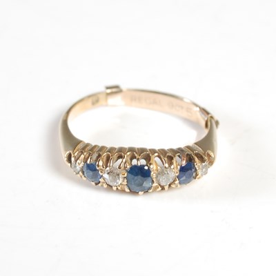 Lot 252 - An 18ct gold sapphire and diamond seven stone...