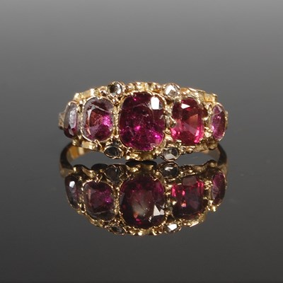 Lot 257 - A yellow metal garnet and diamond chip dress...