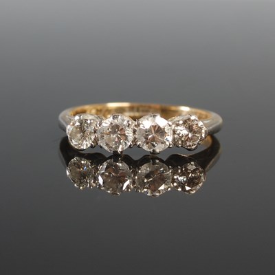 Lot 259 - A yellow and white metal four stone diamond...
