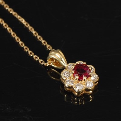 Lot 224 - An 18ct gold ruby and diamond cluster pendant,...
