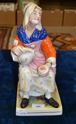 Lot 448 - A 19th century pottery figure of a lady...