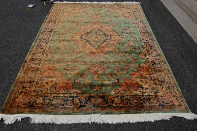 Lot 809 - A 20th century green ground Persian style rug,...