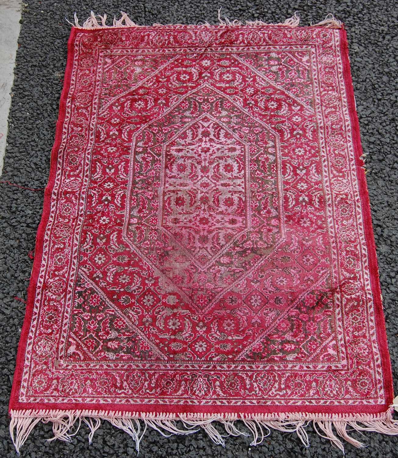 Lot 810 - A small prayer mat, 20th century, the madder...