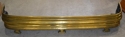 Lot 666 - A 19th century brass fire fender, raised on...