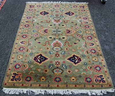 Lot 814 - A 20th century green ground Persian style rug,...