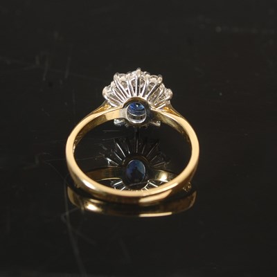 Lot 263 - An 18ct gold sapphire and diamond cluster ring,...
