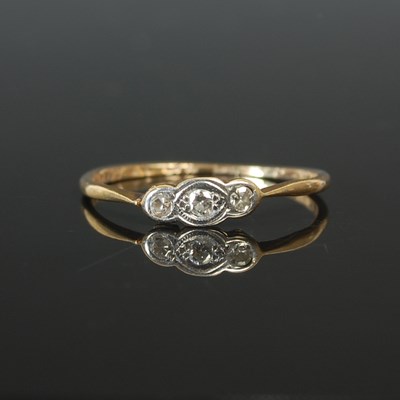 Lot 263C - A yellow and white metal three stone diamond...