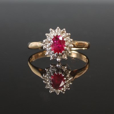 Lot 263D - A 9ct gold ruby and diamond cluster ring, the...
