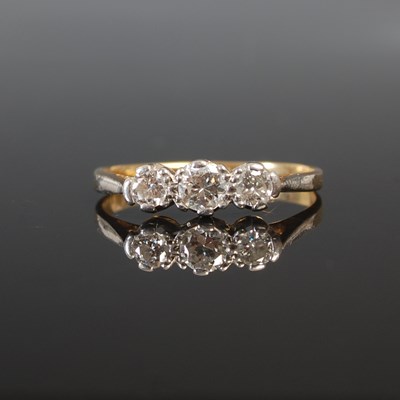 Lot 263J - A yellow and white metal three stone diamond...