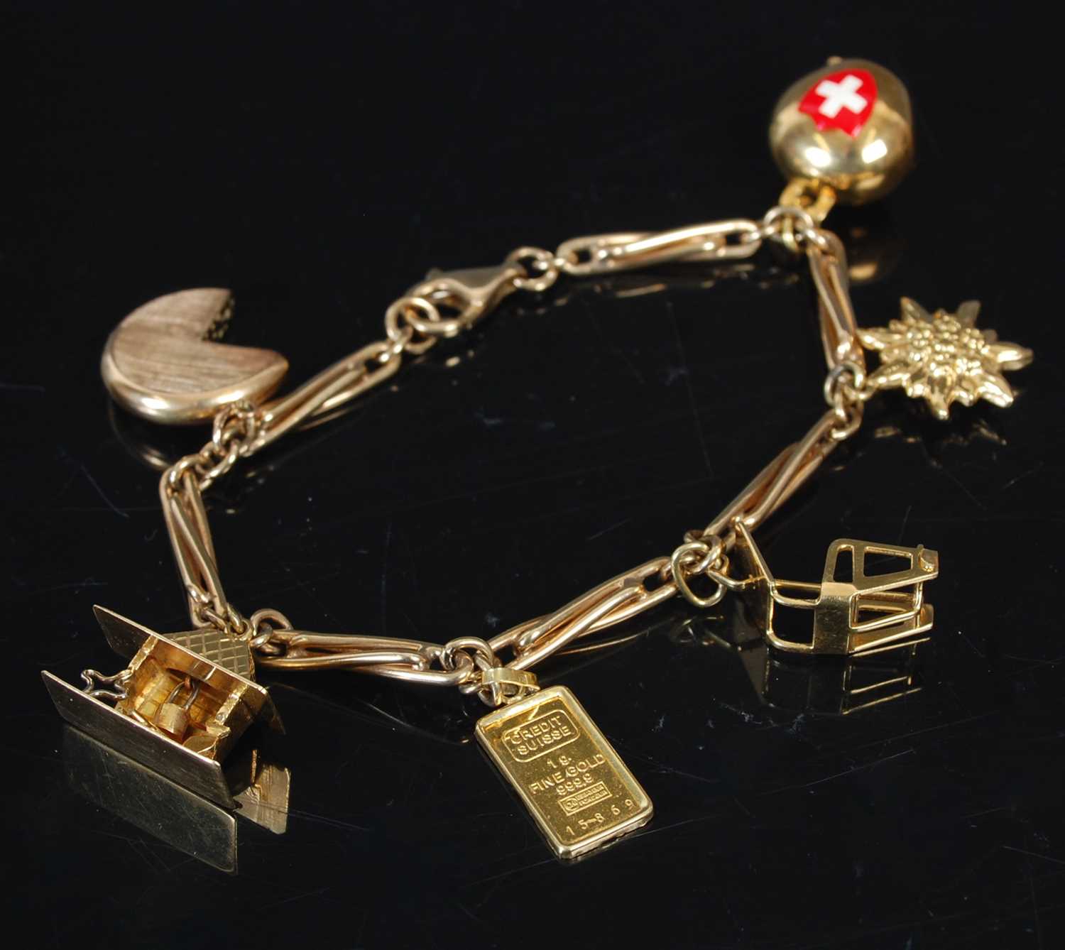 Lot 263 - A 9ct gold charm bracelet set with six charms...