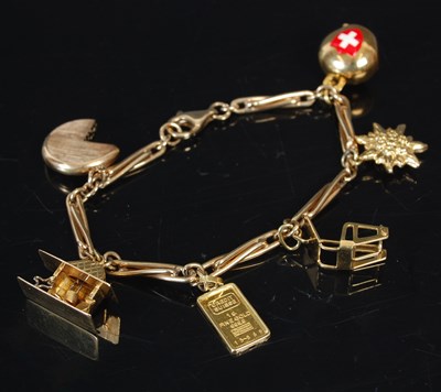 Lot 263Q - A 9ct gold charm bracelet set with six charms...