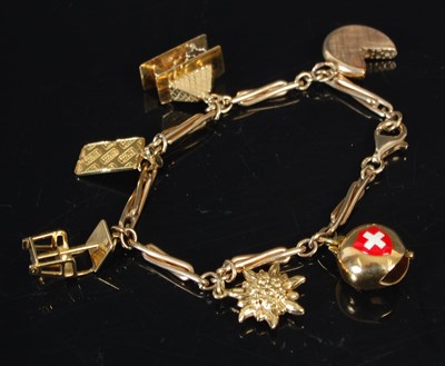 Lot 263 - A 9ct gold charm bracelet set with six charms...