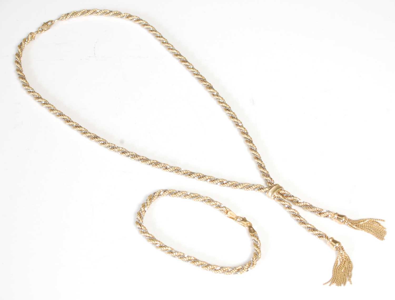 Lot 263 - A white and yellow gold necklace with tassel...