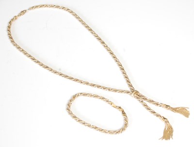 Lot 263U - A white and yellow gold necklace with tassel...