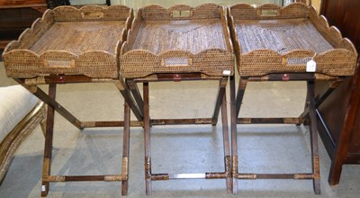 Lot 1062 - A set of three rattan butler trays with...