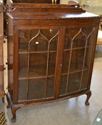Lot 1088 - A 20th century oak cabinet with two astragal...
